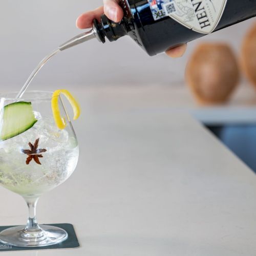 A kitchen scene shows a hand holding eggs above a simple balance scale with a globe and a small plant nearby, as if measuring balance.
